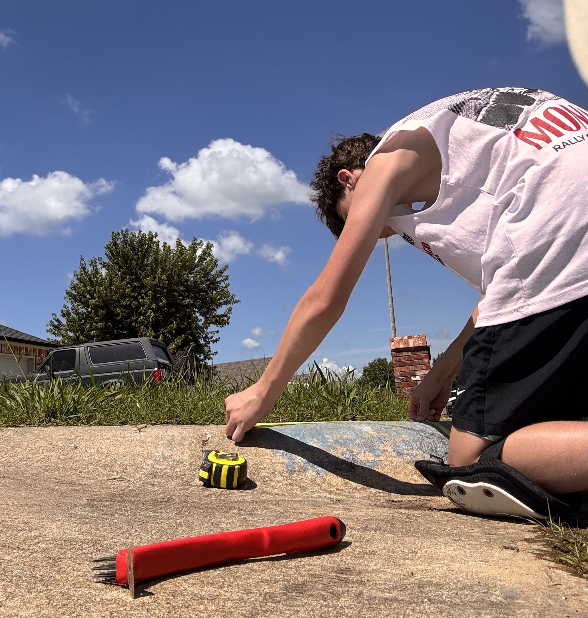 Knox measuring a curb for paint placement